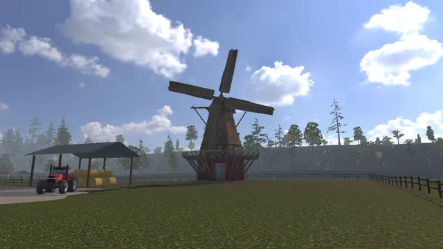 A red tractor by an open-sided barn with a windmill beyond.