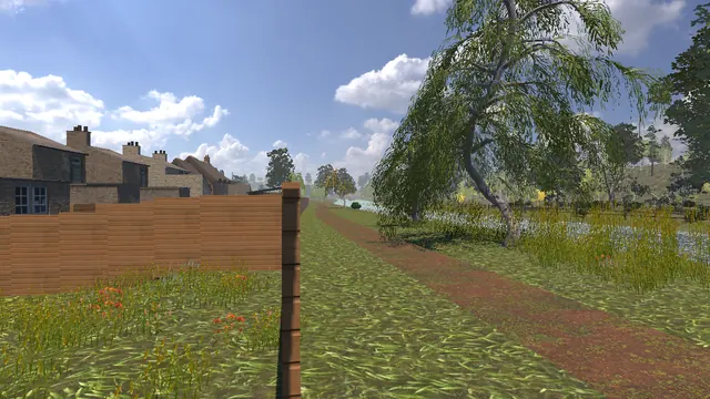 A dirt path along the river bank past a weeping willow, with houses behind a fence.